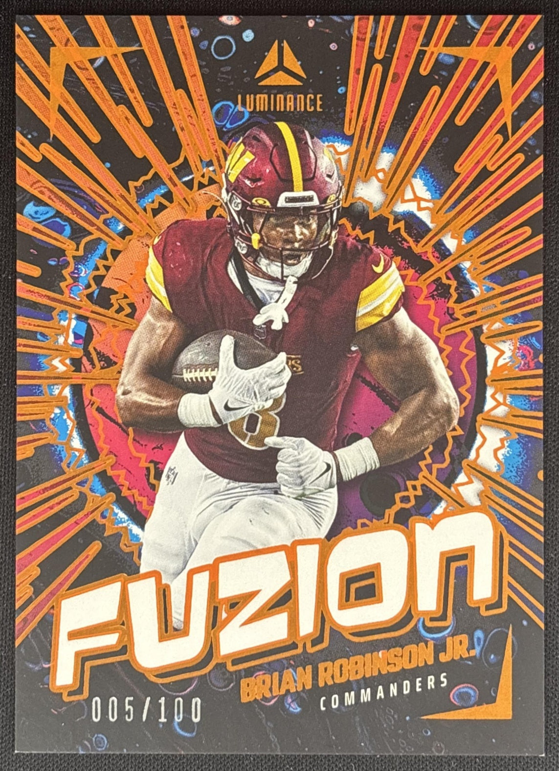 Brian Robinson Jr. 2024 Panini Luminance Fuzion Orange /100 Commanders front